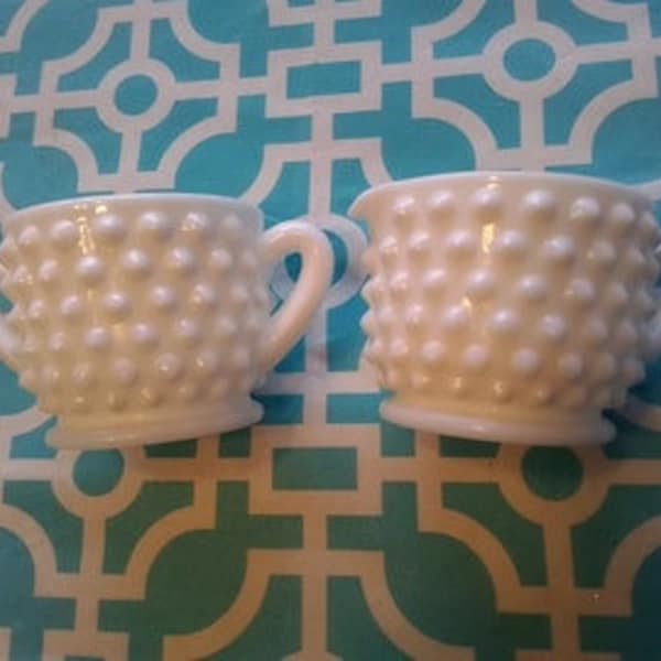 A footed white milk glass small creamer and open sugar bowl in hobnail pattern.  MG 74