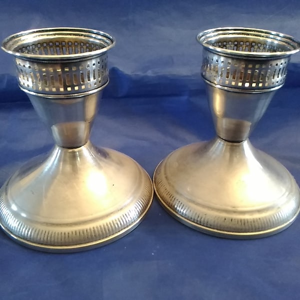 A pair of marked 3.5" Duchin sterling silver pierced candlestick holders with weighted bases.  Candle 444