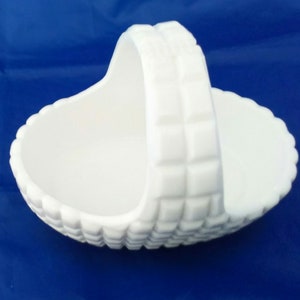 A white milk glass handled basket in a square block pattern.  MG 185