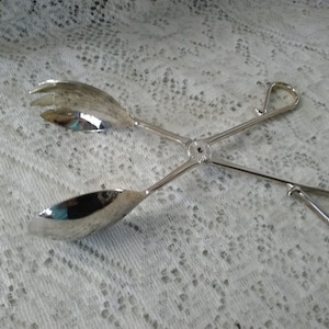 Marked E.P. Zinc, are Italian made scissor style fruit or salad hinged serving fork and spoon set. Dish 1301