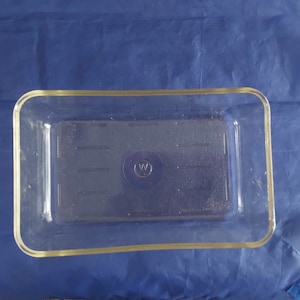A Westinghouse clear rectangular refrigerator dish with a textured bottom that measures 10.25&quot; by 6.5&quot;, from 1940s with no cracks.  CD  174