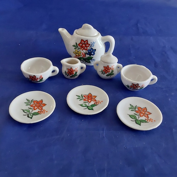 Miniature 10 pc tea set of white porcelain decorated with flowers including tray, teapot, creamer, sugar,  2 cups & 3 saucers.  Mini 19