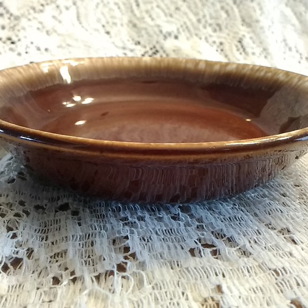 A brown pottery stoneware with beige drip glaze on 6.75" shallow cereal salad or soup bowl.  It is marked USA attributed to McCoy.  SW 216