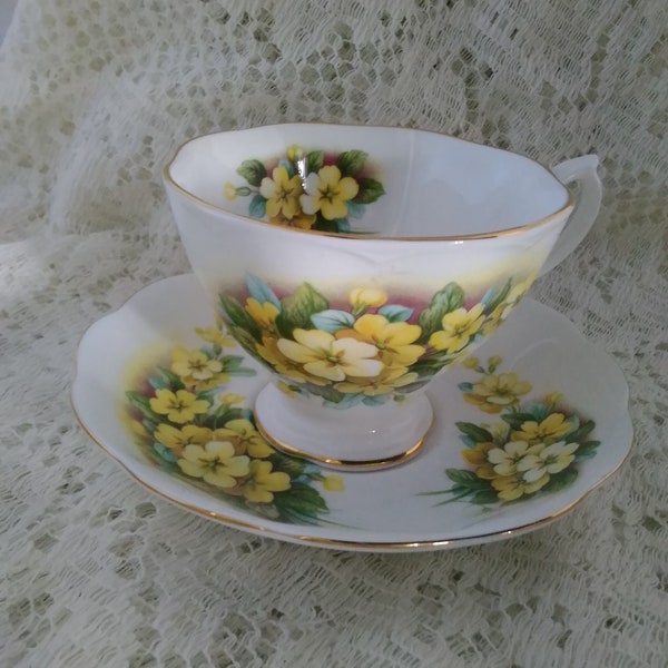 A Royal Albert bone china cup and saucer with yellow primrose flowers and gold trim.  CS 92