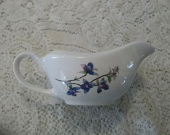 By Citation is a gravy or sauce boat in the Woodhill Design multiple floral sprays of blue, yellow, and purple.  DWS 317
