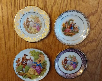 Lot of 4 Limoges France 3 white and 1 pink miniature plates with gold filigree and trim and Fragonard courting couples designs.  Mini 73