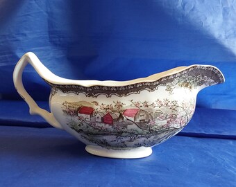 An original Friendly Village gravy boat entitled "Apple Orchard", with the 1940's brown backstamp.  They were made in England.  FV 78