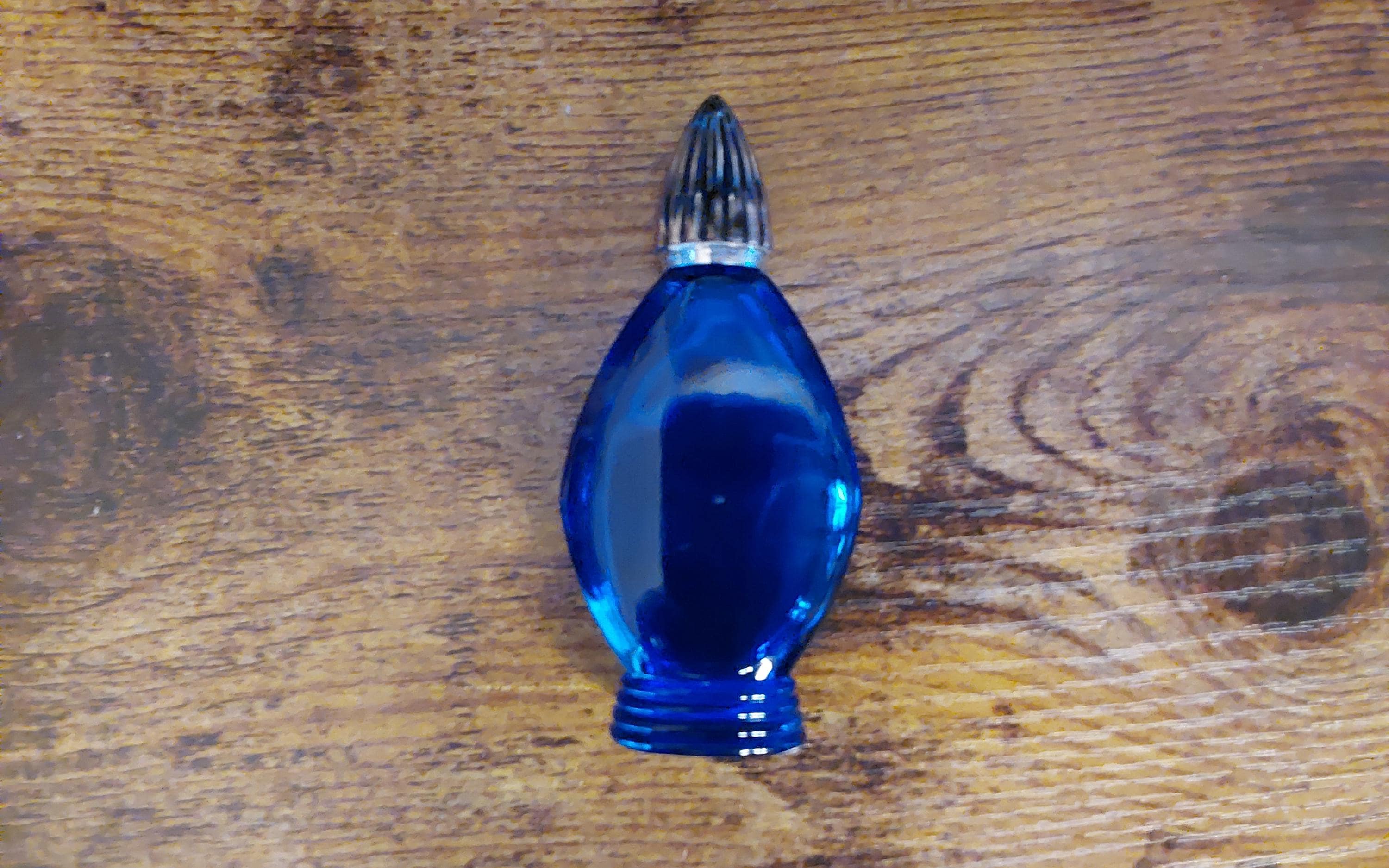An empty Bonjois Evening in Paris cobalt blue perfume bottle with a gold toned lid. Misc 2016
