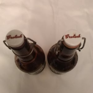 Empty matching pair of Grolsch Lager Dutch brown embossed beer bottles with bale wire and stopper latches.  Bar 827
