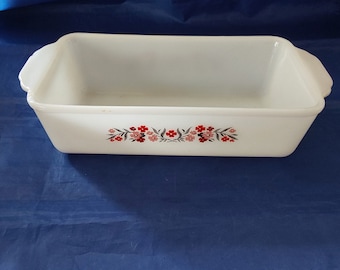 A 1960s Fireking white glass loaf pan  #401 with handles that has the Primrose pattern of small pink and red flowers.  CD 134