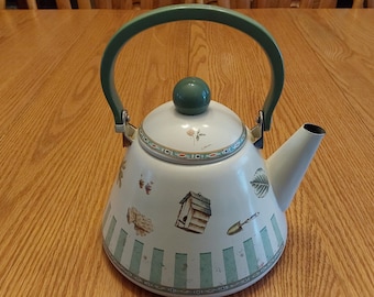 A metal 2.5 quart Pfaltzgraff Naturewood 9" tall teakettle with handle fully extended, from 1990, with a gardening theme.  DWS 834