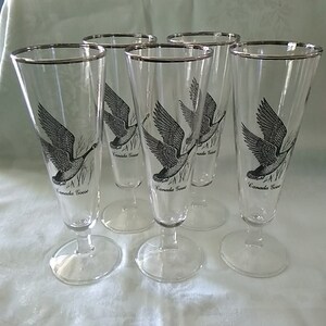 By Federal Glass, is a set of 5 footed 9 fluid ounce pilsner with Canadian Geese and a platinum trimmed rim.  Bar 888
