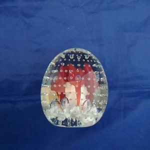 A Joe Rice paperweight with red trumpet flowers and controlled bubbles.  Misc 571