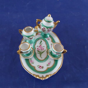 German 7 pc white porcelain dollhouse miniature tea set tray, teapot, 2 cups/saucers in a green design , pink roses and gold trim.  Mini 16