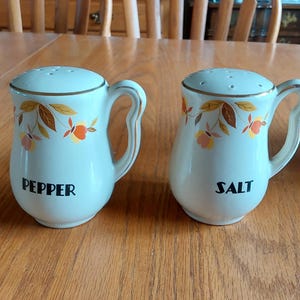 Hall dinnerware large 4.5" tall salt and pepper shakers with an eggshell colored in their Autumn Leaf pattern. Dish 2167