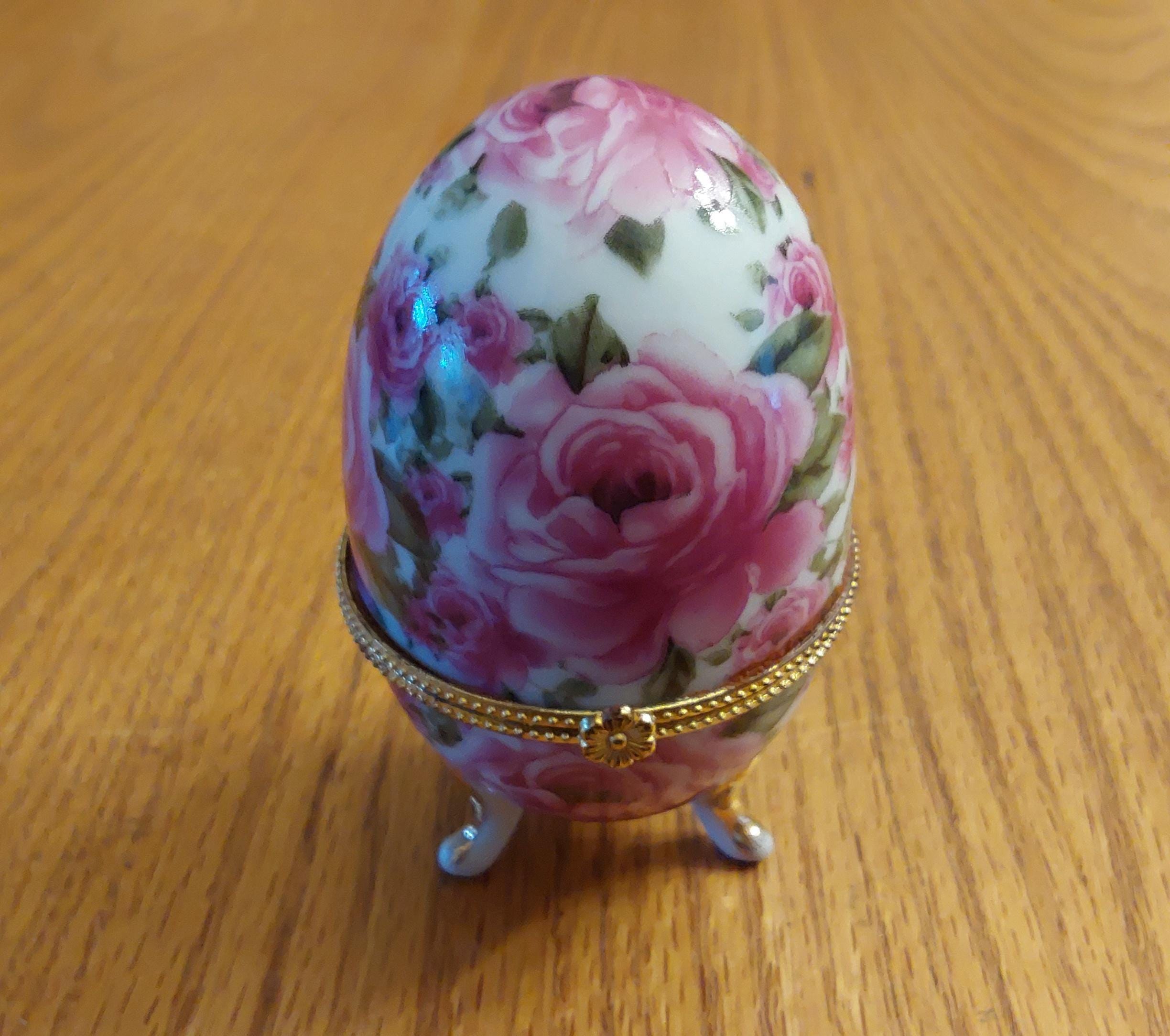 A Limoges Faberge Styled Footed Egg That is White With Pink Rose