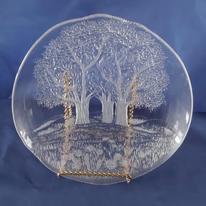 A Studio Nova 7.75" frosted round salad plate, with a grassy valley scene and trees called Sun Valley.  Plate 1033