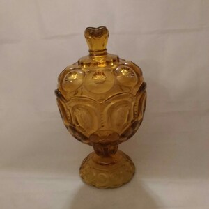 By LE Smith, an amber gold Moon and Star pedestal candy dish with matching lid.  Bowl 798