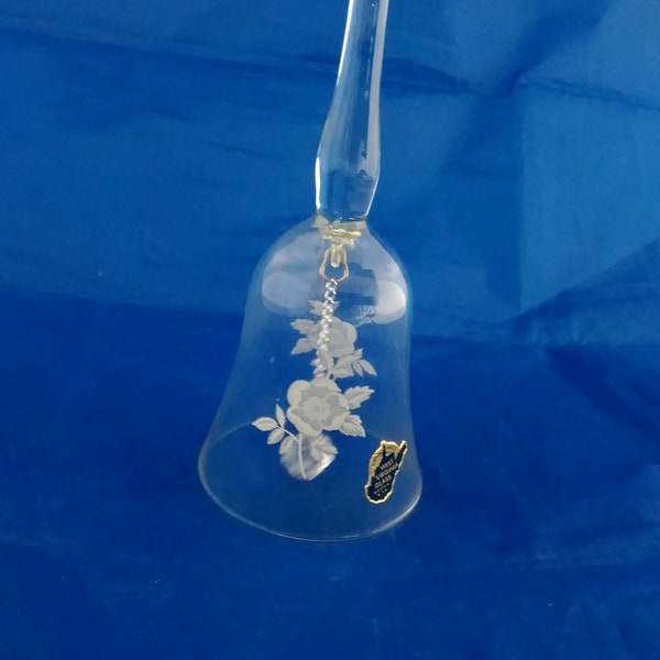 By West Virginia Glass, and it is a clear glass dinner bell with a floral design.  Misc 544