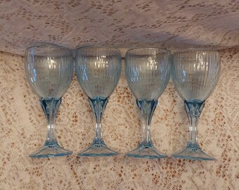 A set of 4 Fostoria matching light blue, 6 oz, 6.5" faceted stemmed wine goblet in a ribbed design, with multiple sets available.  Glass 681