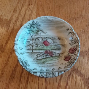 Backstamped Johnson Brothers, The Road Home, is an ivory colored ceramic 3.25" butter pat.  No chips or cracks, but crazed.  Plate 855