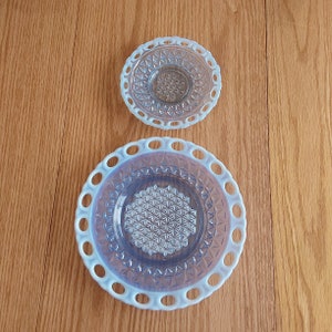 By Imperial Glass, this is 2 pieces of blue glass plates in the Katy pattern with an opalescent moonstone open lace rim.  Plate 776