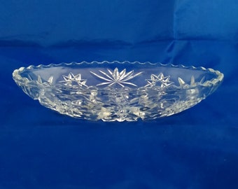 An oval clear glass Anchor Hocking serving dish in Star of David pattern.  Bowl 607
