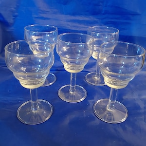 A set of 4 stemmed 5 oz wine glasses with an unusually shaped bowl.  Bar 1056