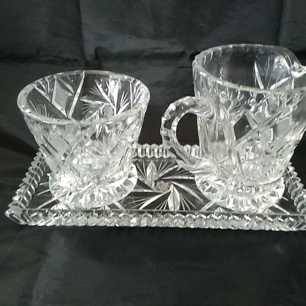 A 3 piece matching set of lead crystal sugar creamer and underplate with the Pinwheel and stippling design.  Dish 1334