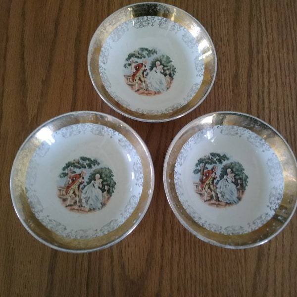 Circa 1950s, are3 ivory Sabin Crest-O-Gold 5 inch fruit bowls with 22kt gold trim and courting couples in the center.  DWS 557