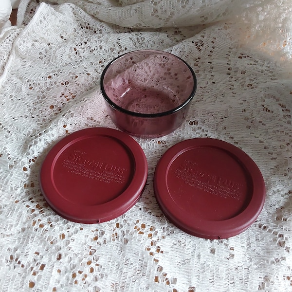 A cramberry Pyrex Storage Plus 1 cup glass bowl with 2 matching lids.   They are number 7202.  Dish 1730