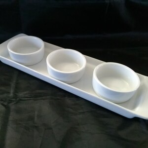 Marked Food Network, a 4 piece white ceramic condiment set of a tray and 3 cups.  Dish 1287