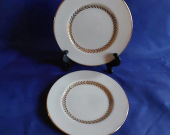 By Lenox, is a set of 2 ivory porcelain 6.5" bread plates in the Imperial pattern of a gold laurel wreath around in the center.  DWS 669