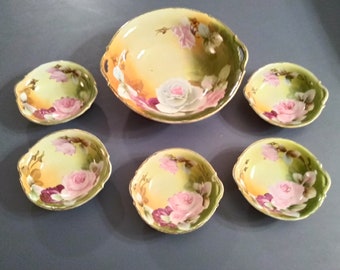 Hand painted roses on a porcelain large berry bowl and 5 small bowl set.  Bowl 467