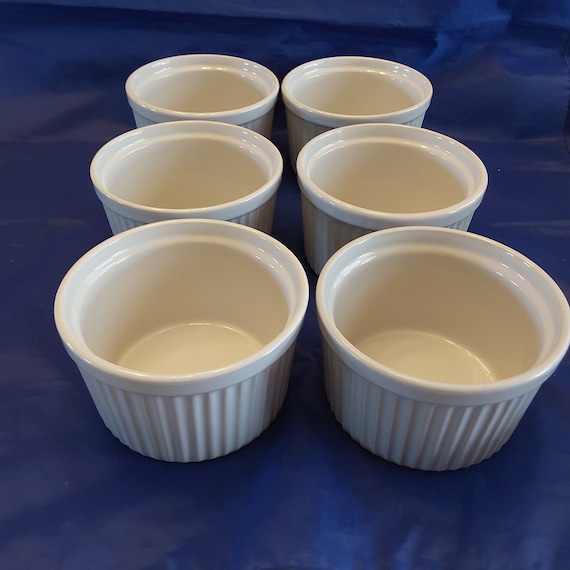 A matching set of 6 Century Brand 13 oz ribbed white ramekins that are4.75" wide and 3" tall with no chip or cracks. Bowl 1313
