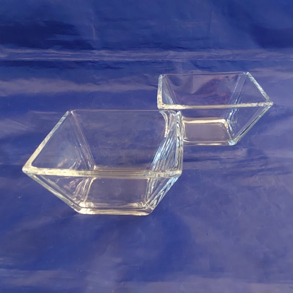 A matching pair of simple,elegant heavy clear glass square bowls that measure 4.25" by 2.25".  No chips cracks or scratches.   Bowl 1336