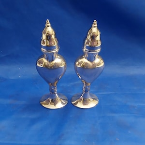 A set of antique LA France silverplated #832 pedestal 5.25" salt and pepper shakers in a heart shape with original box.  Dish 1917
