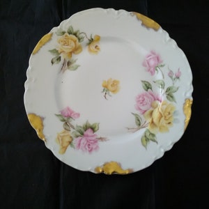 Marked Haviland France porcelain hand painted 9.75&quot; white plate decorated with pink and yellow roses with gold trimmed rim.  Plate 569