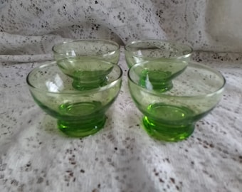 A matching set of 4 footed Anchor Hocking sherbet dishes in a bright green apple glass.  Bowl 1150