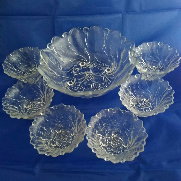 An Indiana Glass matching footed clear glass 7 pc berry bowl set in the Wild Rose pattern.  Bowl 376