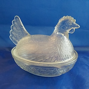 By Indiana Glass, a clear hen on a basket, is a lidded candy dish.  A piece of nostalgia from the 1950s.  Misc 778
