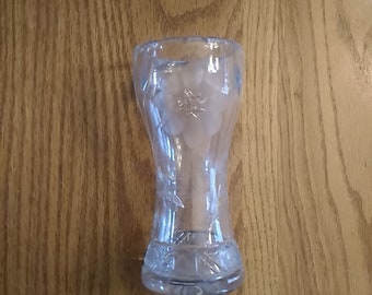 A 6 inch tall corseted lead crystal bud vase with an etched floral design.  Vase 340