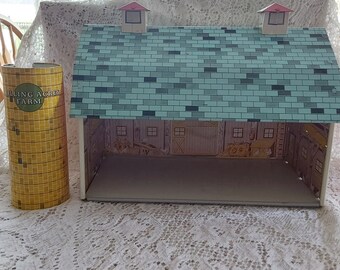 A 1950s Rolling Acres Farm in a metal tin lithograph complete red barn w/sliding back door and a yellow silo without a roof.  Misc 1429
