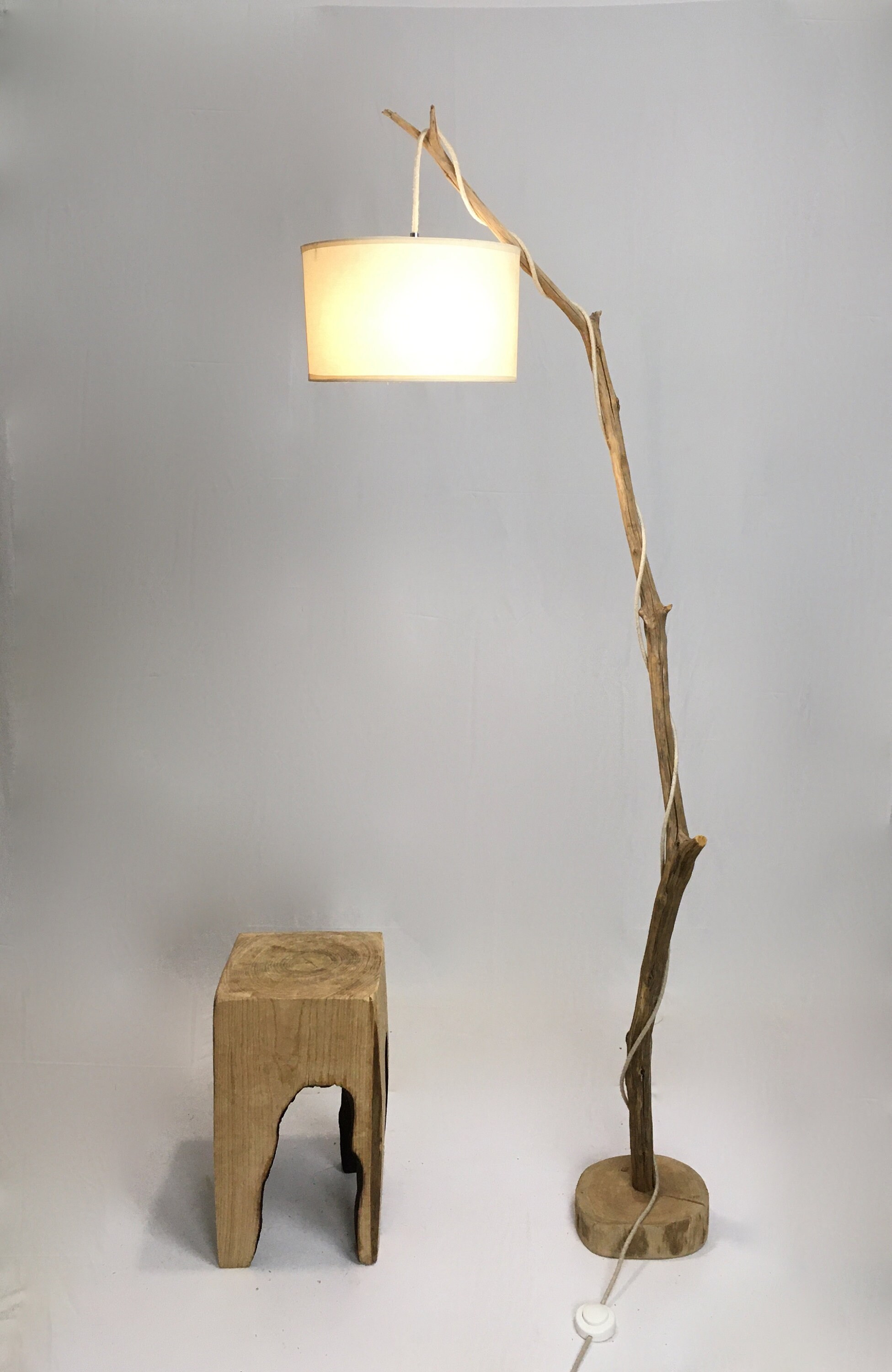 Old branch floor lamp with white hanging lamp shade and cloth cable