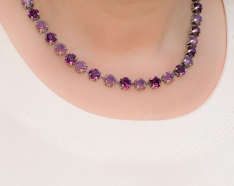 May include: A silver necklace with a gradient of purple rhinestones.