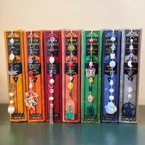 May include: A set of ten vintage bookends with colorful beaded bookmarks. The bookmarks feature various charms, including a butterfly, a star, a heart, and a flower. The books are all titled "Junior Classics" and feature different stories from Greek mythology, tales of courage, and more.