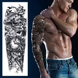 May include: Black and white temporary tattoo design featuring a skull wearing a fireman's helmet, a clock, and other details. The tattoo is shown on a person's arm.