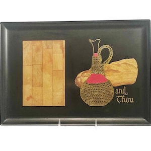 May include: Black rectangular serving tray with a wood-grain design. The tray features a decorative image of a woven wine bottle, a loaf of bread, and the text "and thou".