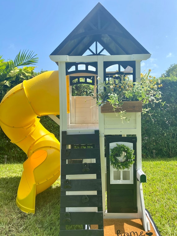 wooden playhouse with slide