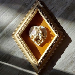 Vintage Porcelain Bisque Cherub Figural Plaque, Ornate Diamond Shaped Frame, Orange-Gold Velvet Matte